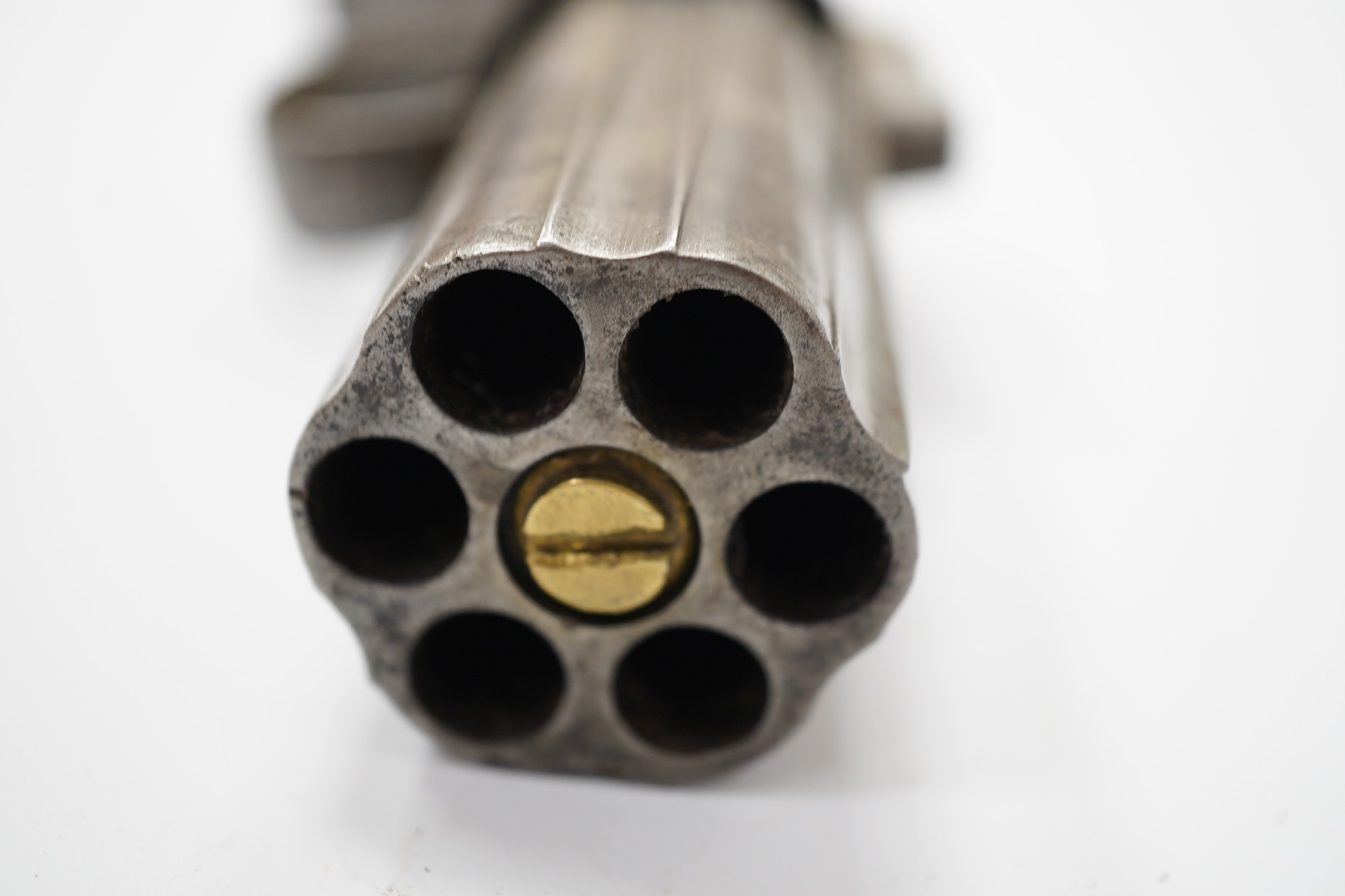 A six shot self-cocking percussion pepper box revolver, with fluted barrels, Birmingham proofed, round frame, and scroll engraved wooden grips, barrel 6.5cm. Condition - fair, alterations to the frame and grip.